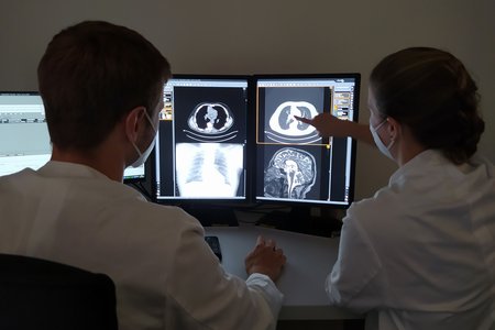 Ärzte des Radiologischen Instituts am Ortenau Klinikum in Offenburg werten am PC-Bildschirm Bilddaten nach einer Computertomographie aus.
